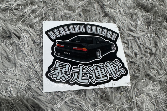 Sticker with text and graphics on a textured gray surface